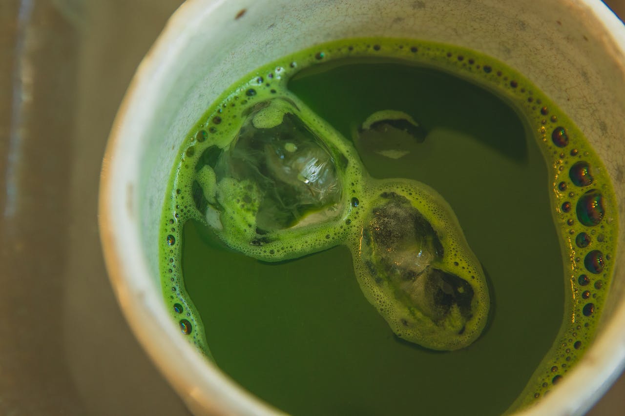 Vibrant green matcha in a clay cup
